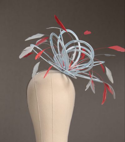 Ladies' formal Baby Blue and Coral Pink medium feather and satin loop fascinator hat. Suitable for a wedding or ladies' day at the races