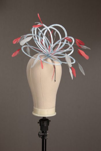 Ladies' formal Baby Blue and Coral Pink medium feather and satin loop fascinator hat. Suitable for a wedding or ladies' day at the races