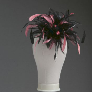 Ladies wedding or races black and coral pink small feather and satin loop fascinator hat