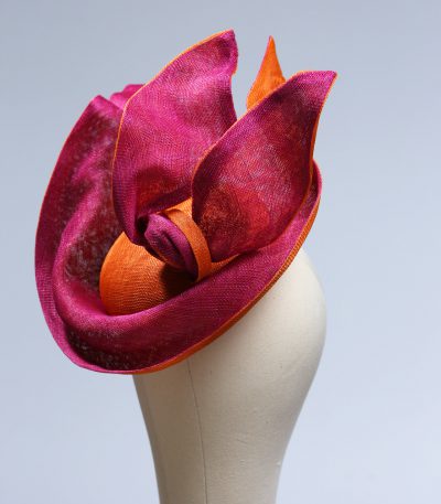 Hot Pink sinamay saucer hat set on a orange button pillbox fascinator