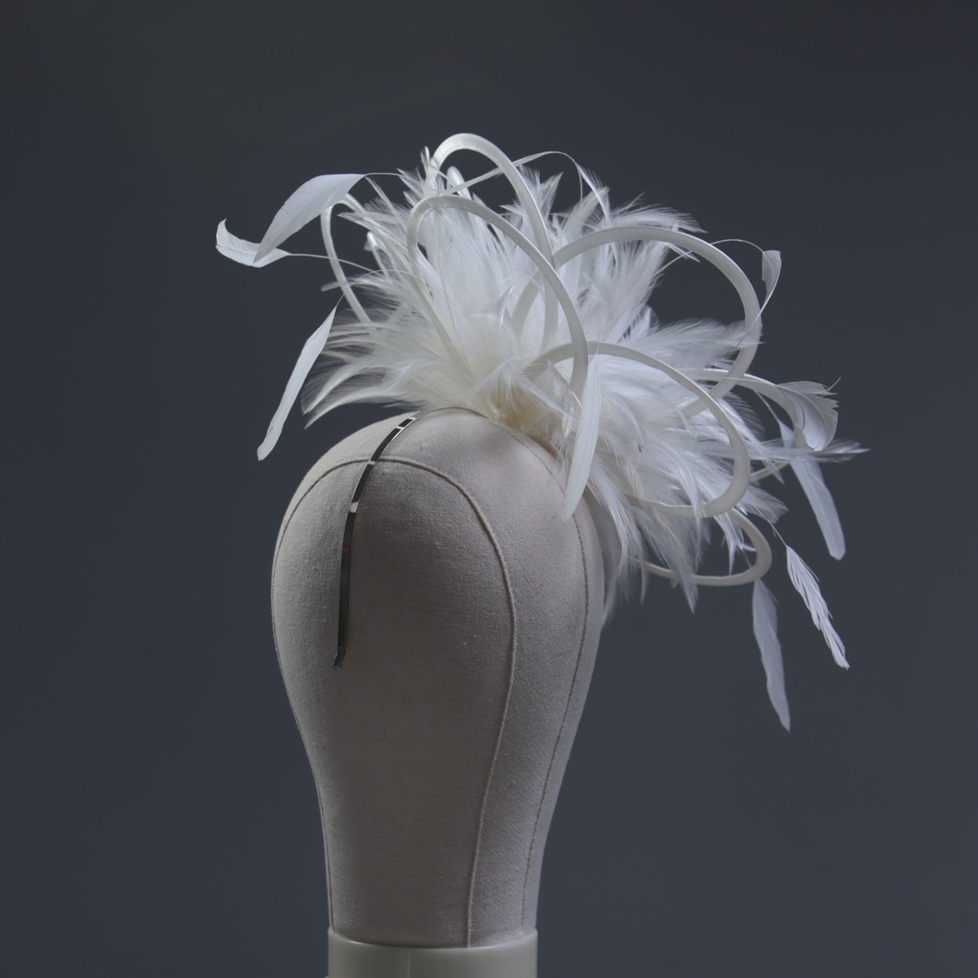 Ladies formal Ivory medium feather and satin loop fascinator hat. Suitable for a wedding or ladies day at the races
