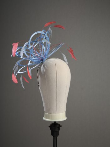 Ladies' formal Cornflower Blue and Coral Pink medium feather and satin loop fascinator hat. Suitable for a wedding or ladies' day at the races