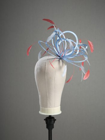 Ladies' formal Cornflower Blue and Coral Pink medium feather and satin loop fascinator hat. Suitable for a wedding or ladies' day at the races