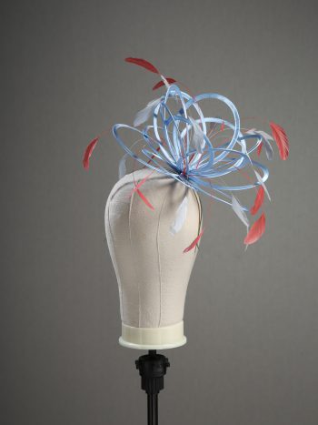 Ladies' formal Cornflower Blue and Coral Pink medium feather and satin loop fascinator hat. Suitable for a wedding or ladies' day at the races