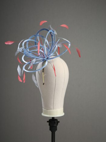 Ladies' formal Cornflower Blue and Coral Pink medium feather and satin loop fascinator hat. Suitable for a wedding or ladies' day at the races