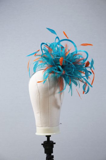 Ladies' formal Turquoise and Orange medium feather and satin loop fascinator hat. Suitable for a wedding or ladies' day at the races