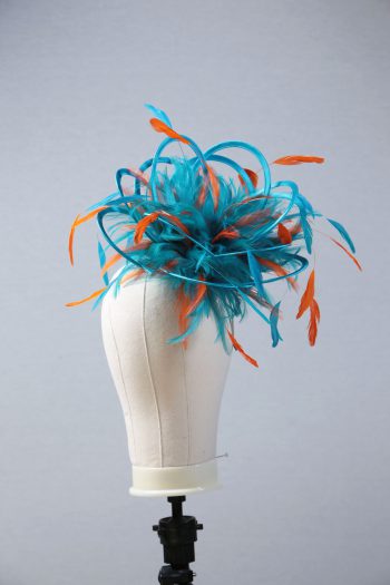 Ladies' formal Turquoise and Orange medium feather and satin loop fascinator hat. Suitable for a wedding or ladies' day at the races