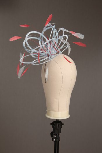 Ladies' formal Baby Blue and Coral Pink medium feather and satin loop fascinator hat. Suitable for a wedding or ladies' day at the races