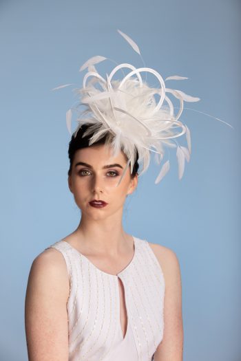 white satin loop and feather fascinator hat set on a headband