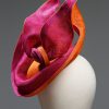 Hot Pink sinamay saucer hat set on a orange button pillbox fascinator