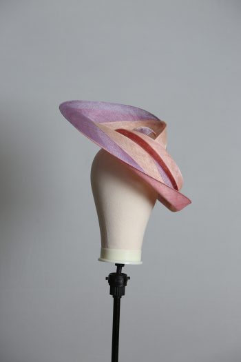 Pink lilac and oyster sinamay swirl fascinator hat set on a teardrop base