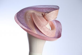 Pink lilac and oyster sinamay swirl fascinator hat set on a teardrop base