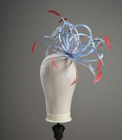 Ladies' formal Cornflower Blue and Coral Pink medium feather and satin loop fascinator hat. Suitable for a wedding or ladies' day at the races