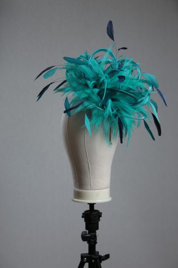 Ladies' formal Turquoise and Navy Blue medium feather and satin loop fascinator hat. Suitable for a wedding or ladies' day at the races